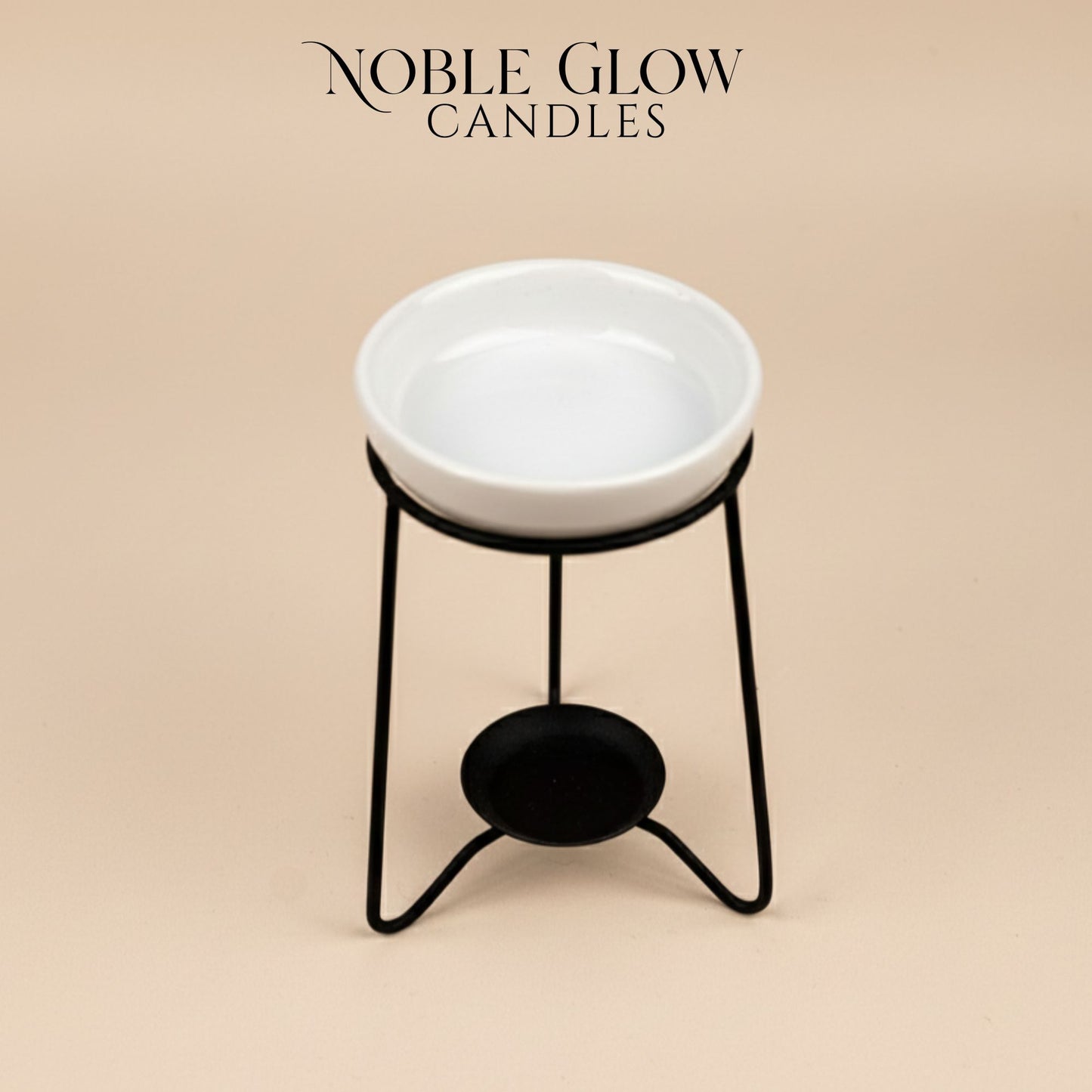 White ceramic bowl on a black metal stand with 'Noble Glow Candles' branding on a beige background.