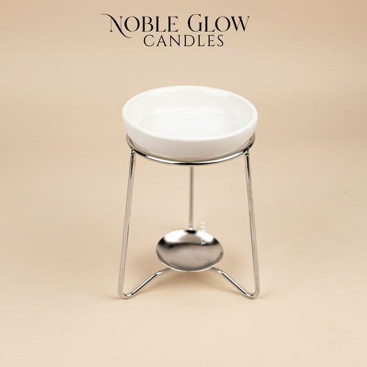 White ceramic candle holder with metal stand on a beige background, featuring 'Noble Glow Candles' branding.