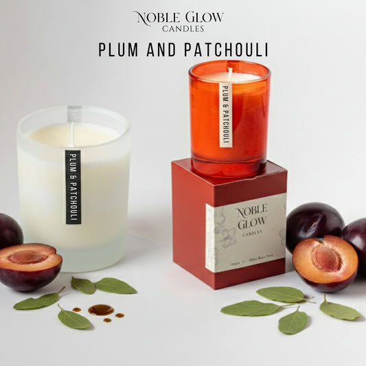 Noble Glow Plum and Patchouli candles with packaging on a white background